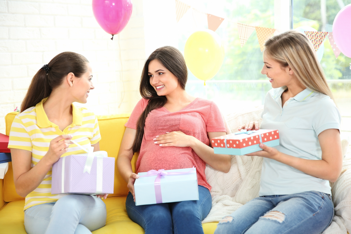 des amies offrant des cadeaux à une femme enceinte