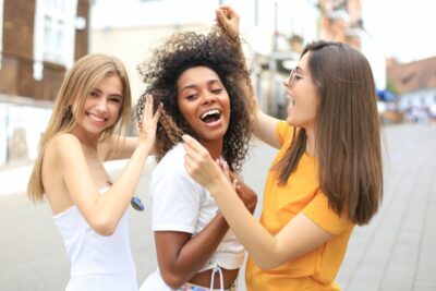 Jeunes femmes heureuses qui ont de beaux cheveux grace a des soins adaptes a leur type de cheveux